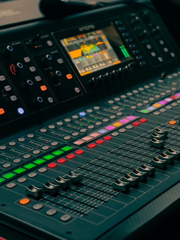 Mastering the First Impression: Your intriguing post title goes here Detailed view of a professional audio mixing console with colorful controls and display.